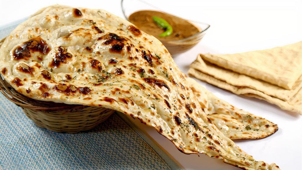 Butter Naan · Traditional Punjabi leavened white bread baked in our clay oven and lightly buttered.