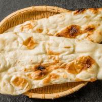Plain Naan · Traditional Punjabi leavened white bread baked in our clay oven.