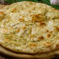 Pesto Naan · Traditional Punjabi leavened white bread topped with pesto sauce and baked in our clay oven.