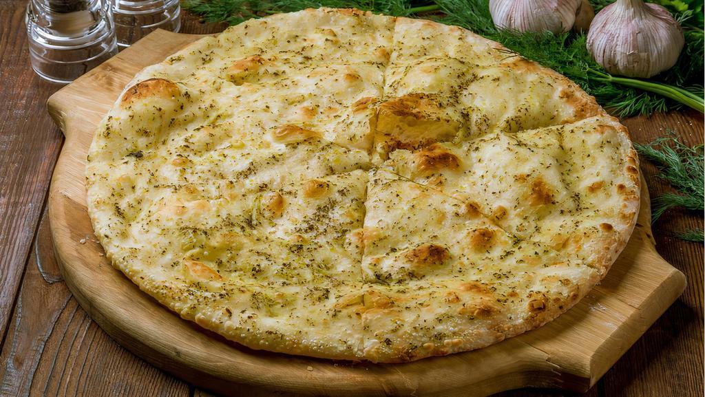 Pesto Naan · Traditional Punjabi leavened white bread topped with pesto sauce and baked in our clay oven.