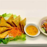 Samosa · Minced chicken and sweet potatoes sauteed with curry sauce, Wrapped and deep fried.