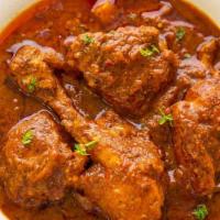 Chicken Vindaloo · Chicken cooked with fresh ginger, garlic, potatoes and red chili based gravy with Indian her...