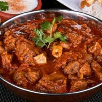 Goat Curry · Goat cooked in a traditional blend of curry spices.