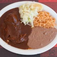 Mole · Chicken cooked in a Traditional Chocolate Sauce. Served with Rice, Beans, and Tortillas.