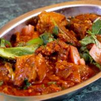 Goat Karahi with Bone · Diced Goat Meat Cooked in a Deep Wok with Fresh Tomatoes, Onions, Ginger, Garlic, Spices.