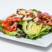 Cobb  · Bacon, chicken breast, avocado, tomato and marinated onions served on mixed greens topped wi...