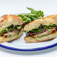 El Desperdicio · Baked seasoned pork, bacon, marinated onions and mixed greens on baguette with an herb aioli...