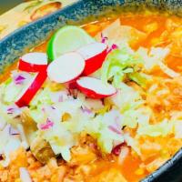 Pozole Rojo · Pork, hominy, garnished with iceberg lettuce, red onions, lime, radishes and housemade spicy...