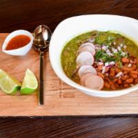 Carne en Su Jugo · Beef sauteed with bacon and onions simmered in its own juice with tomatillo garnished with c...