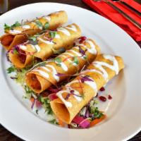 Flautas de Camote · Vegan. Sweet potatoes flautas garnished with cream of almond, Mexican coleslaw, pomegranate ...