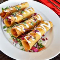 Vegan Flautas de Camote · Sweet potatoes flautas garnished with cream of almond, mexican cole slaw, pomegranate & pick...