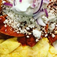 Chilaquiles · Scrambled eggs with tortilla chips, chorizo, onions, and queso fresco, tossed with special r...
