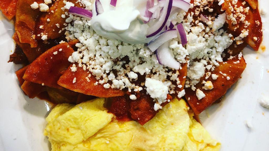 Chilaquiles · Scrambled eggs with tortilla chips, chorizo, onions, and queso fresco, tossed with special red sauce.