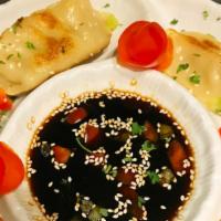 Chicken Potstickers · Chicken, green onion, ginger, and garlic, with soy ginger sauce, garnished with green onions...