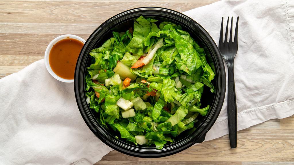 House Salad · Green leaf lettuce, diced tomatoes, cucumbers, and onions served with balsamic dressing.
