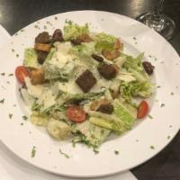 Caesar · Chopped romaine in a classic caesar dressing with Parmesan cheese, croutons and anchovies.