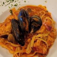 Pescatore · Clams, mussels, tiger shrimp, salmon, halibut in a tomato lobster sauce over risotto.