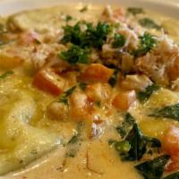 Crab ravioli  · with tomatoes, spinach in cujun cream sauce