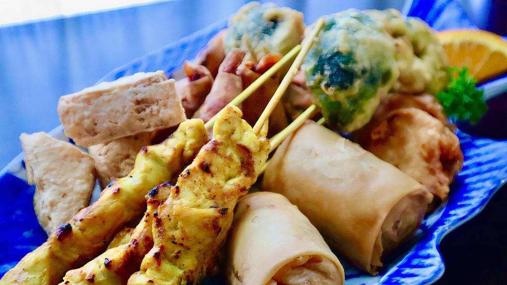 Dusita's Sampler · Combination of satay chicken, Thai rolls (vegetables), prawn rolls, mixed vegetable tempura and tofu triangles, served with peanut sauce, sweet and sour sauce and cucumber sauce.