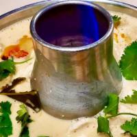 Tom Kha Chicken · Sliced chicken in spicy and sour coconut soup with lemongrass, kaffir leaves, galangal, mush...