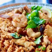 Pineapple Fried Rice · Pan-fried rice with chicken, prawns, pineapple, cashew nuts, carrots, green peas, corns, egg...
