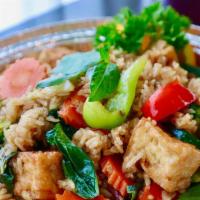 Basil Fried Rice · Spicy pan-fried rice with soft-fried tofu, broccoli, baby corns, carrots, sweet basil leaves...