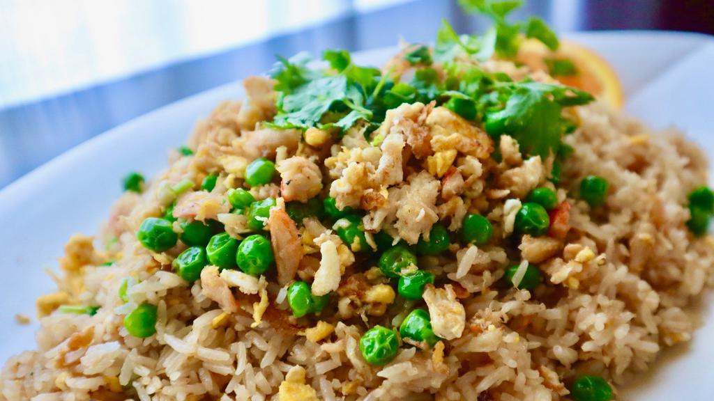 Crab Fried Rice · Pan-fried rice with crab meat, egg green onion and green peas.