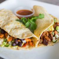 Mami Cheli’s Taco · Homemade corn tortilla, (choice of meat or grilled mushrooms), cilantro, onions, beans, guac...
