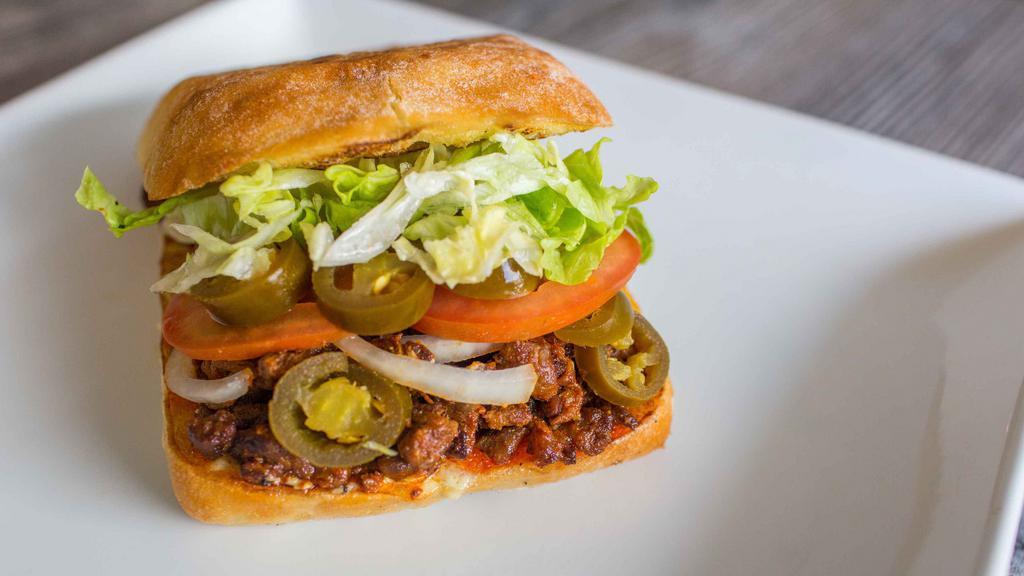 Torta · Toasted torta bread with homemade spread (has dairy), choice of meat, tomatoes, onions, jalapeños, and lettuce.