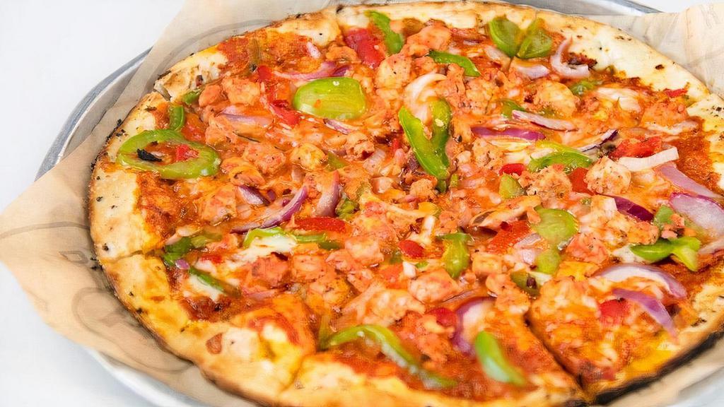Tandoori Vegi Pizza · Locally Inspired Indian-Spice Tandoori combined with onion, bell pepper, roasted red pepper, red pepper flakes and paired with your premium crust choice. Topped with fresh cilantro after backing.