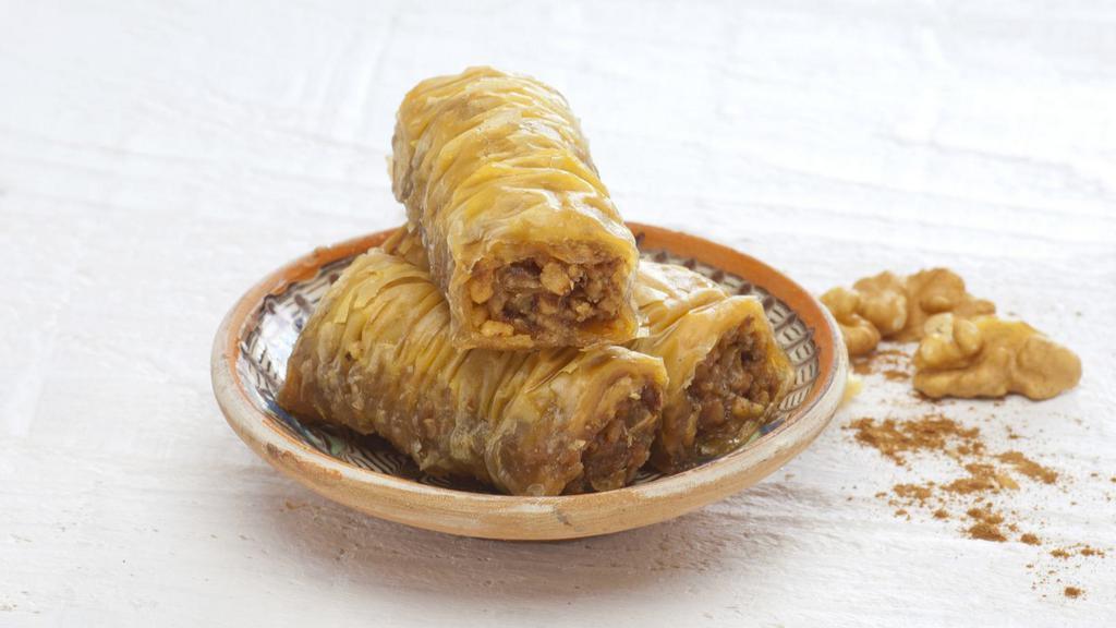 Walnut Baklava Roll · Buttery dough soaked in honey and sugar and rolled with tender pieces of walnut.