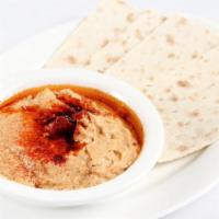 Hummus · A puree of garbanzo beans with garlic, lemon juice, extra virgin olive oil, and tahini serve...