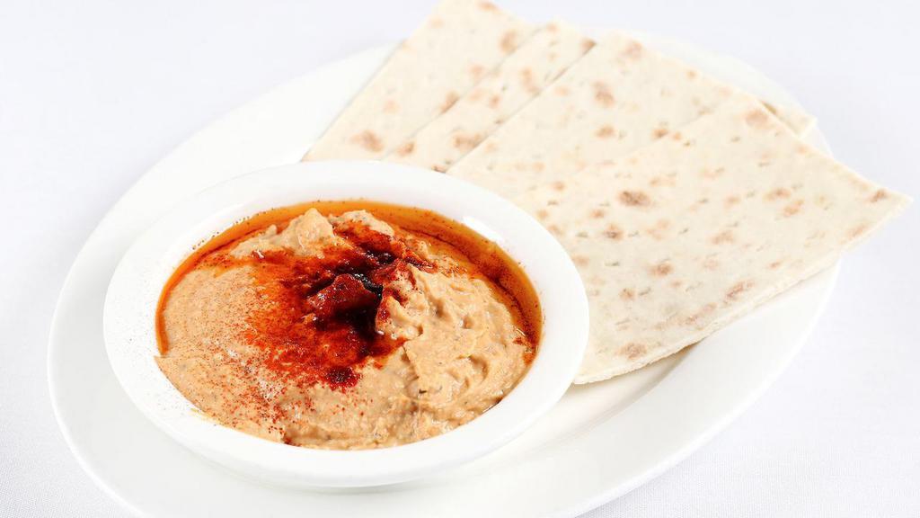 Hummus · A puree of garbanzo beans with garlic, lemon juice, extra virgin olive oil, and tahini served with flat bread.