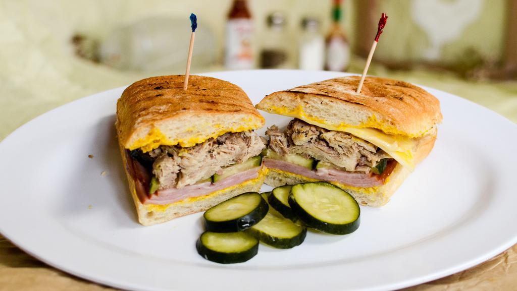 F10. Cuban · Smoked pork shoulder, ham, pickles, mustard and Swiss cheese on panini roll.