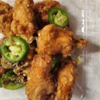 Salt & Pepper Chicken Wings · 8 Fried wings and sautéed with jalapeño, green onion, and garlic