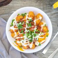 Loaded Tots · Tater tots, nacho cheese sauce, applewood bacon bits, drizzled ranch dressing and chopped gr...