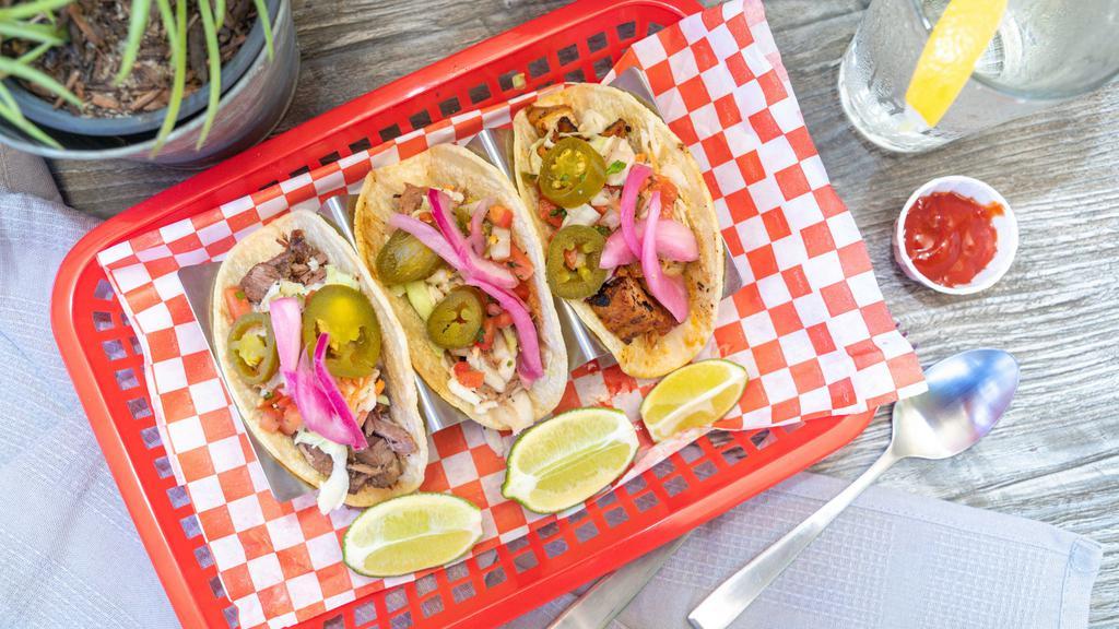 BBQ Tacos · 3 Tacos, Corn Tortilla,  Filled with your choice of bbq meat, Slaw, Jalapeno, Pickled Red Onion