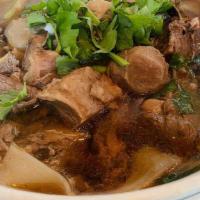 B04. Combination Beef Noodle Soup · Noodle with sliced beef, beef balls, beef stew, Chinese broccoli and bean sprout in spicy be...
