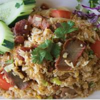E05. BBQ Pork Fried Rice · Fried rice with BBQ pork, Chinese sausage, egg, white onion, green onion, and tomato topped ...