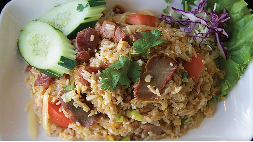 E05. BBQ Pork Fried Rice · Fried rice with BBQ pork, Chinese sausage, egg, white onion, green onion, and tomato topped with
cilantro and cucumber.