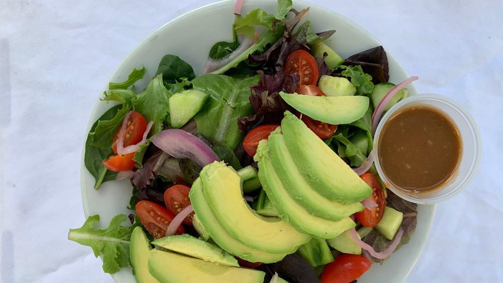 Kahlo Salad · Spring mix with tomatoes, onions, and avocado tossed in a raspberry balsamic dressing.