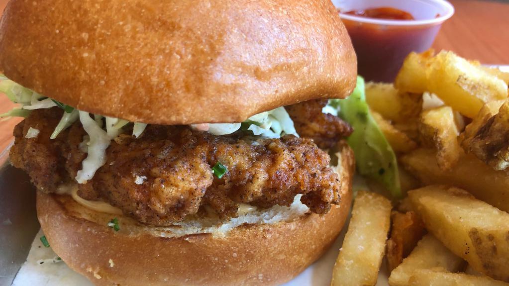 Fried Chicken Sandwich · Buttermilk chicken with our 10 spice rub fried to perfection served on a brioche bun with chipotle remoulade,  pickled onion, and a ranch slaw. Come with frjtz and curry ketchup.