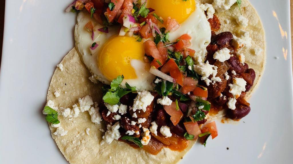 Huevos Rancheros · 2 eggs your way on 2 flour tortillas, with black beans , pico de gallo, feta cheese, and home fries.