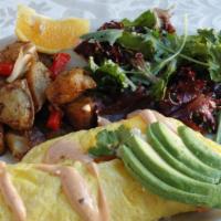 The Louvre Omelet · Three egg omelet with Crab cake, goat cheese, mango, and cilantro served with chipotle remou...