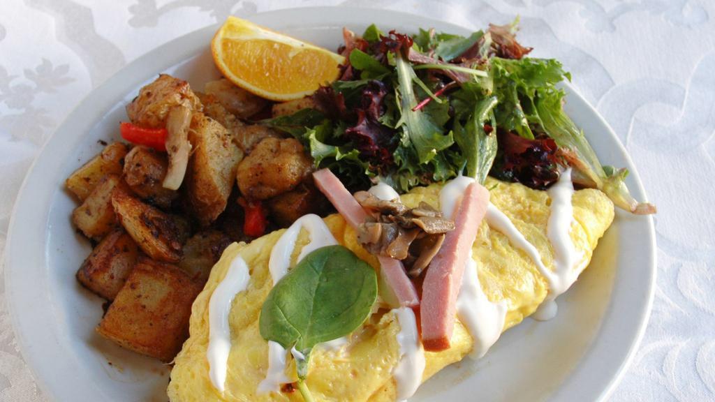 The Whitney · Three egg omelette with Canadian bacon , mushrooms, spinach and creme fraiche served with home-fried potatoes.