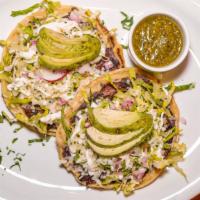 Sopes (2pcs) · Two lightly fried masa dumplings, frijoles refritos, lettuce, sour cream, and cotija cheese ...
