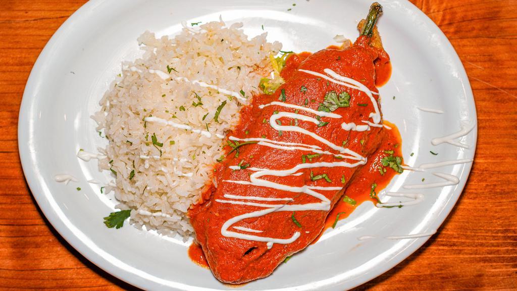 Chile Relleno Plato · Grilled and lightly battered poblano pepper filled with cheese, mushrooms, plantains and epazote topped with tomato sauce, lettuce, sour cream and queso fresco. Served with Spanish rice, choice of beans, and handmade tortillas