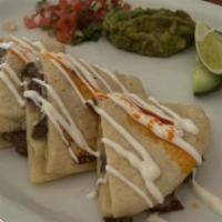Chavindecas · Two handmade tortillas sandwiched with Oaxaca cheese and meat, sour cream, guacamole, salsa.
