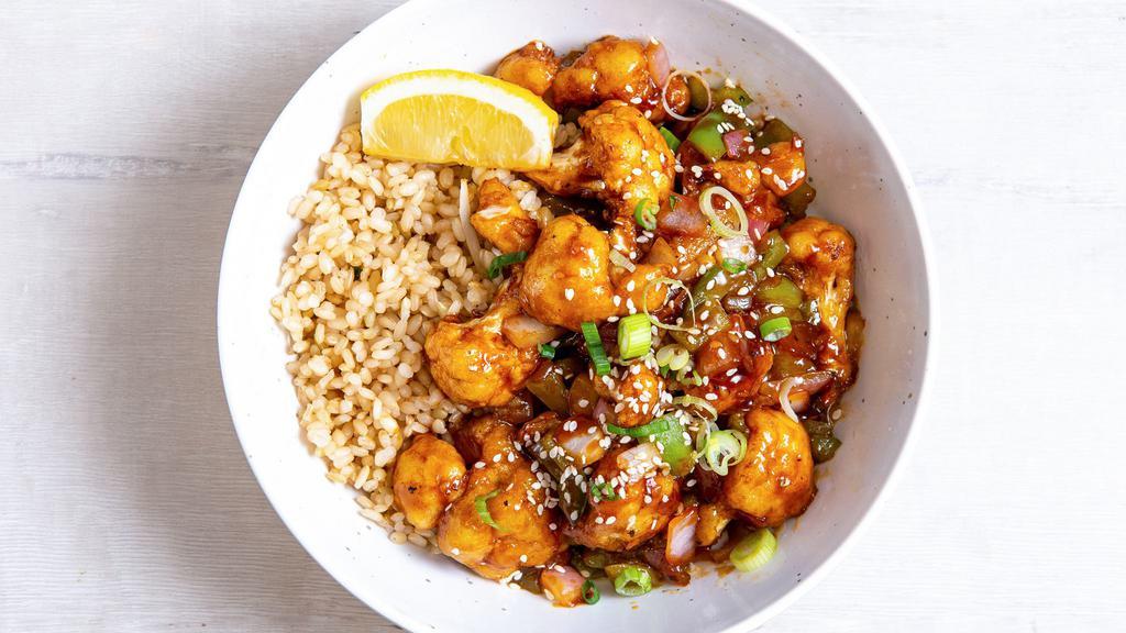 Orange Sesame Cauliflower · Flash-fried cauliflower with peppers & onions, green onions, sesame seeds, and our house-made orange sesame sauce. Served with a lemon wedge, and a base of your choice. (gluten-free)