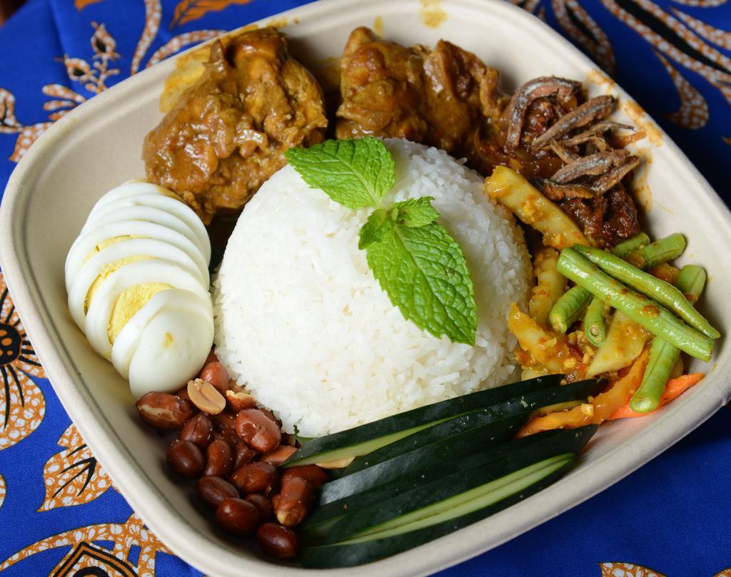 2. Nasi Lemak · Chicken rendang served with coconut rice, crispy sambal anchovies, toasted peanuts, cucumbers and boiled egg.